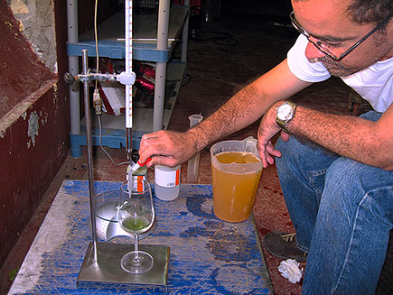 Isaac testing acidity in white grenache must.